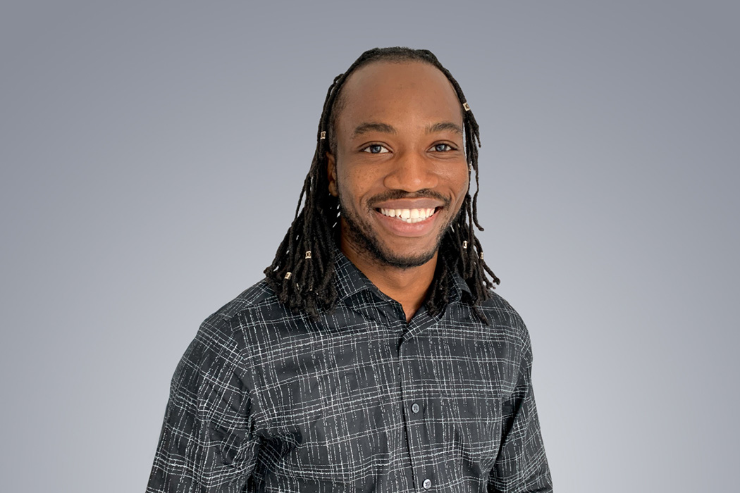 Heroic Headshot on grey background of business casual man taking remote virtual headshot.