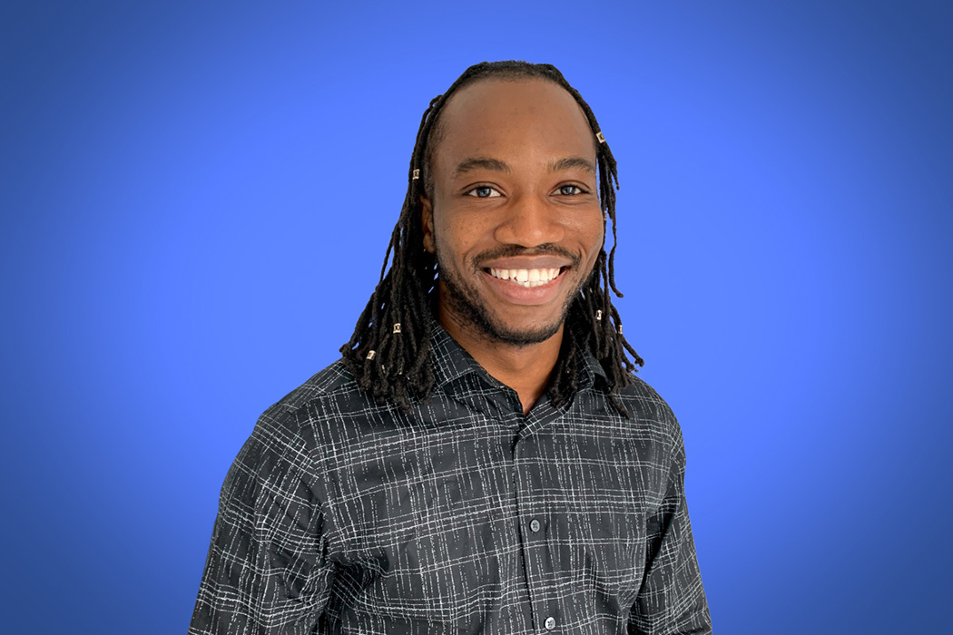 Heroic Headshot on blue background of business casual man taking remote virtual headshot.