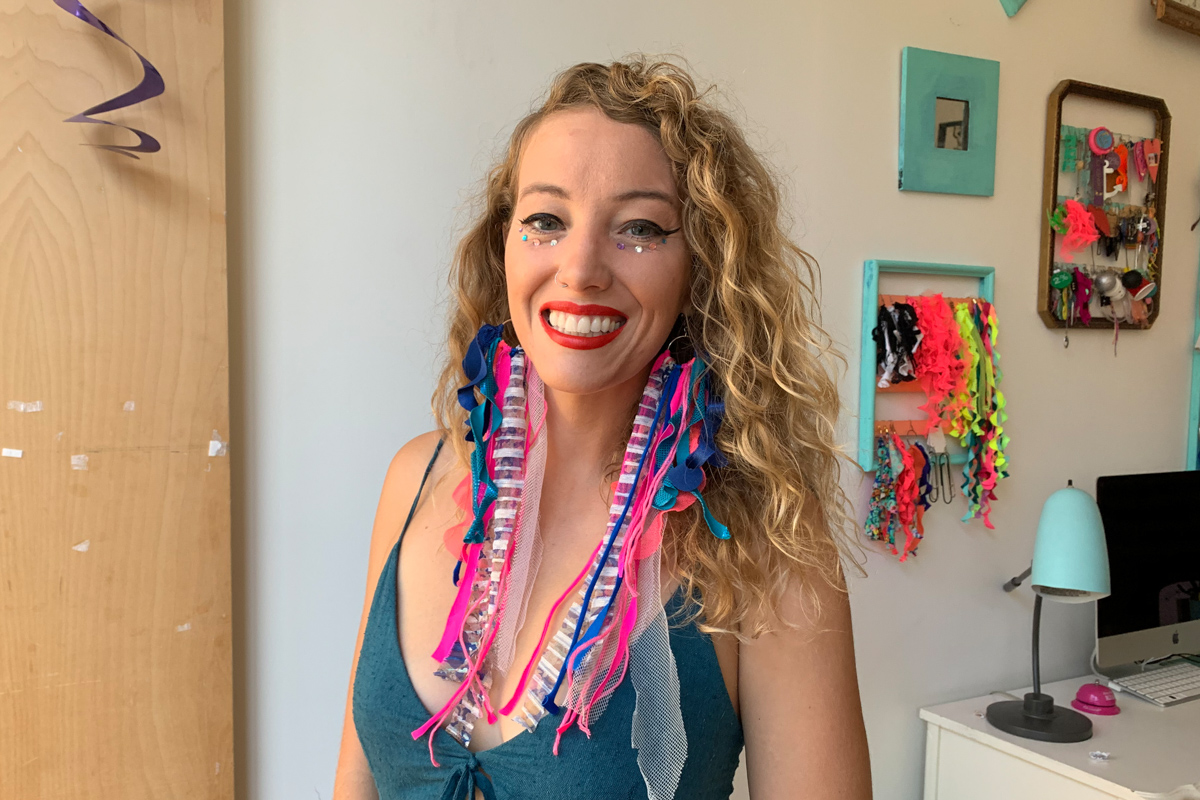 Heroic Headshots woman with colorful clothes taking remote virtual headshot from home.