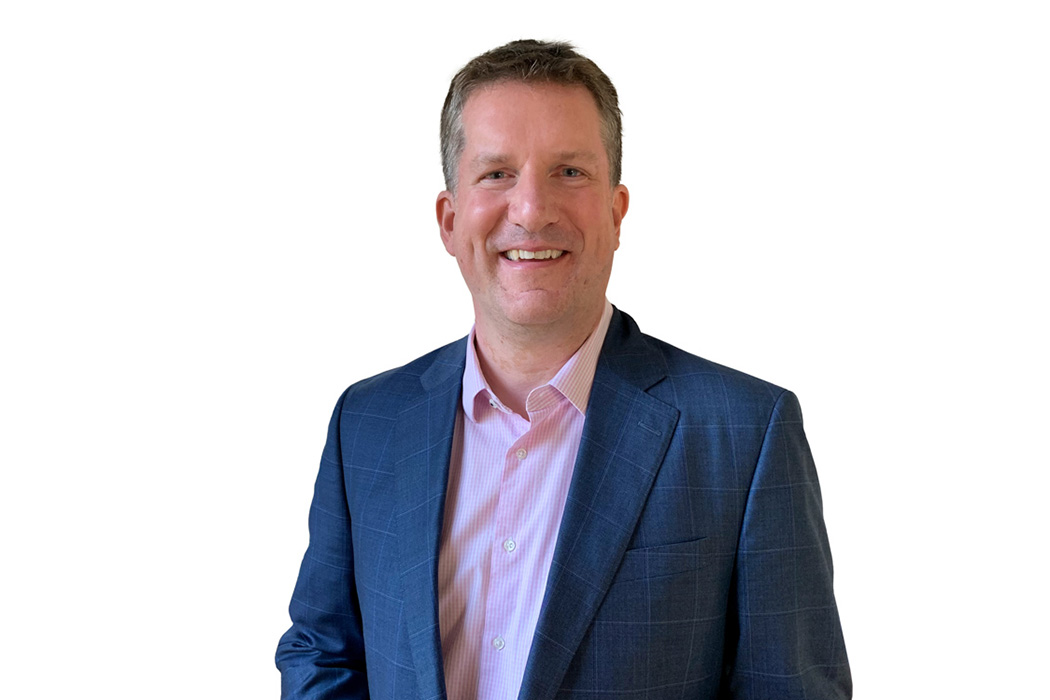 Heroic Headshot on white background of business man in suit taking remote virtual headshot.