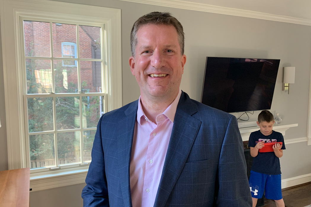 Heroic Headshots business man in suit taking remote virtual headshot from home