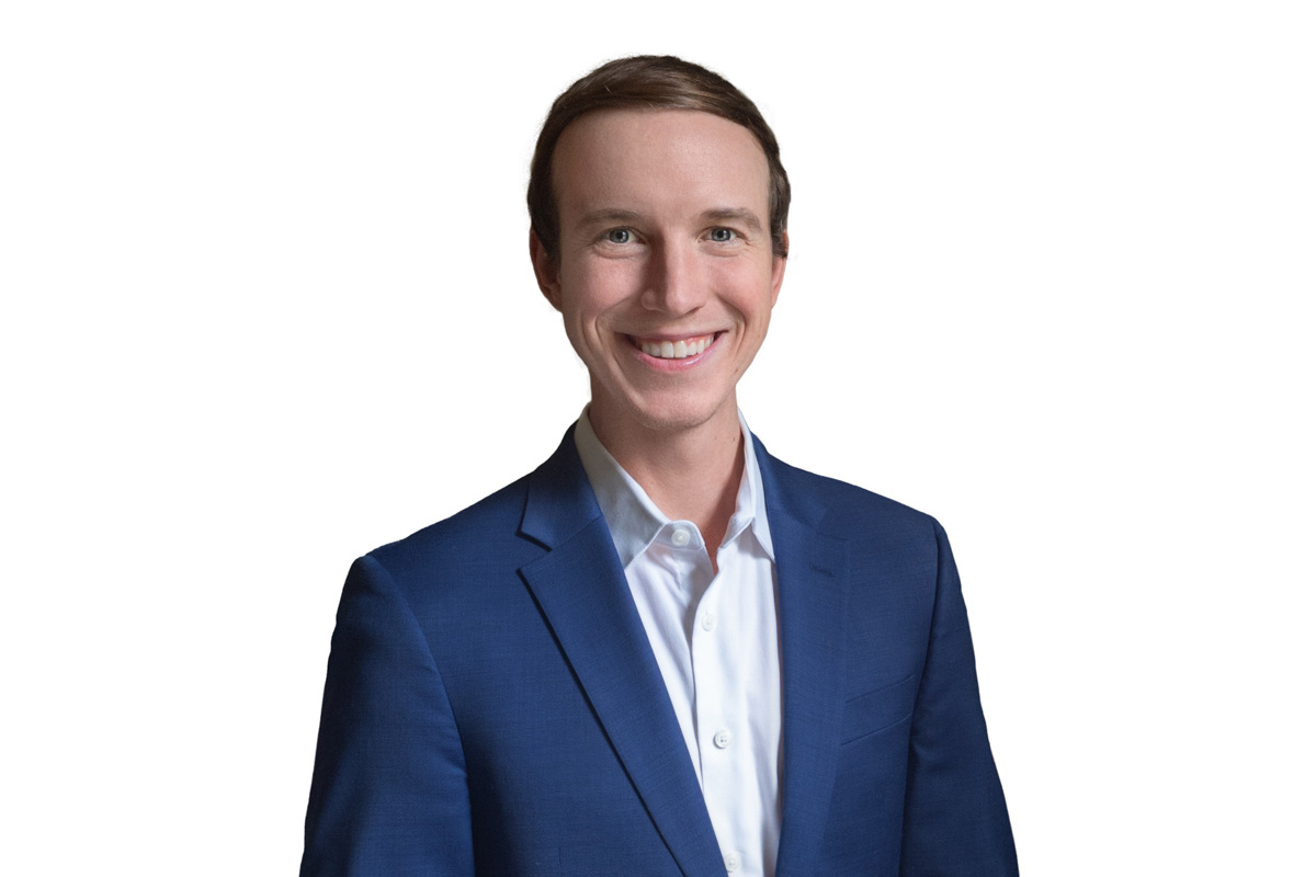 Heroic Headshot on white background of business man in suit taking remote virtual headshot.