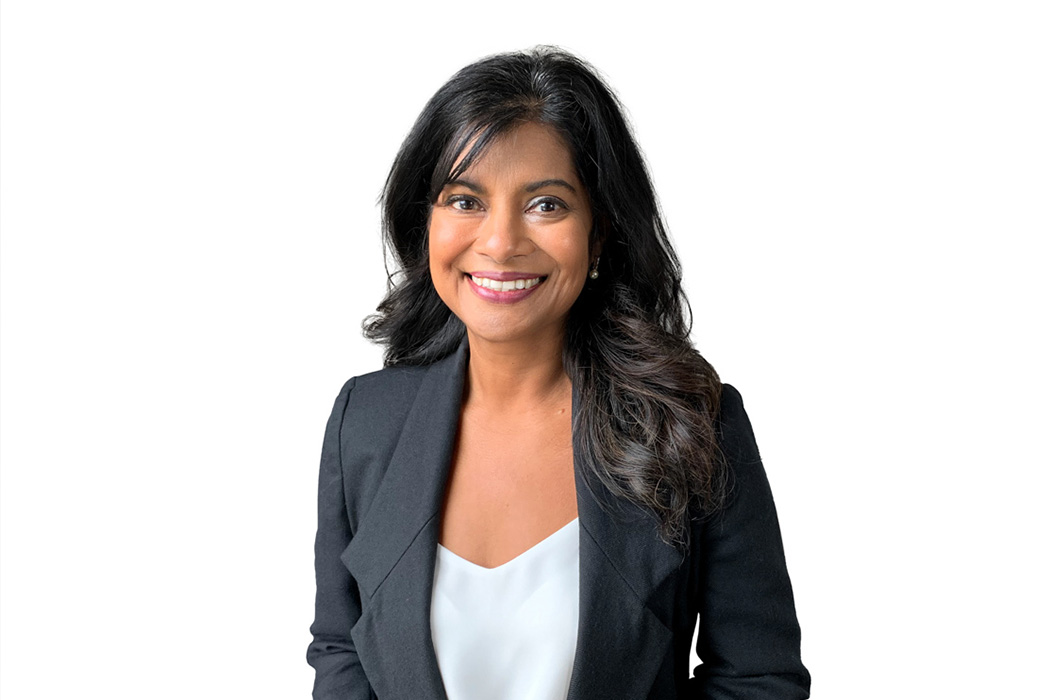 Heroic Headshot on white background of business woman in suit jacket taking remote virtual headshot.