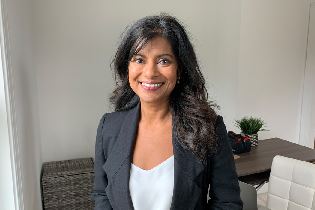 Heroic Headshots business woman in suit jacket taking remote virtual headshot from home.